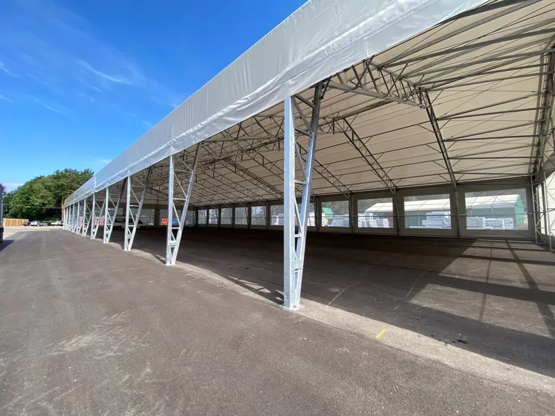Open-sided industrial canopy over a working yard