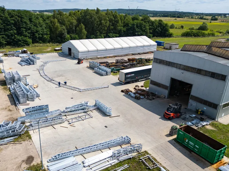 Aerial view of temporary warehouse buildings beside loading yards and lorries
